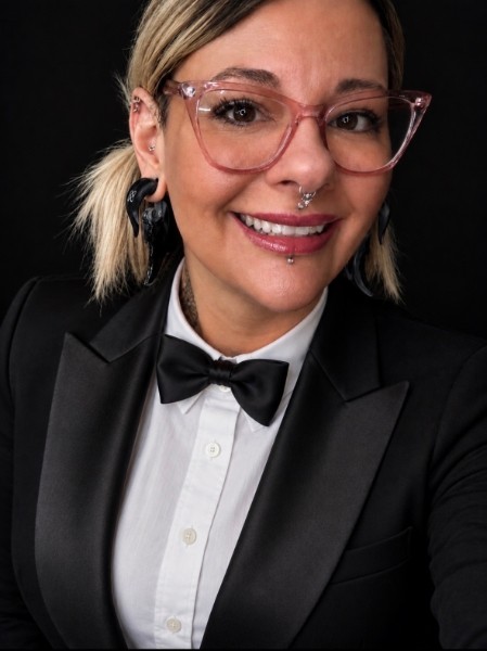 Ann Wilson, owner, tattoo artist and piercer, in a tuxedo