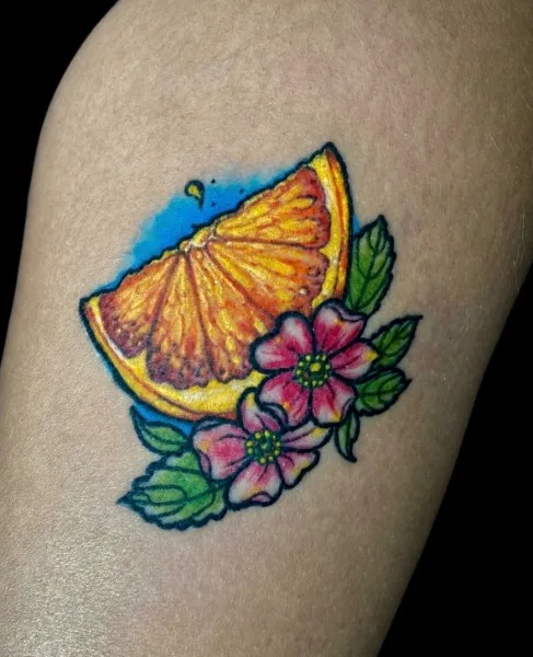 Orange slice and blossoms — Color neo-traditional tattoo on thigh