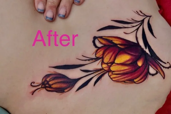 After the cover-up on the ribs / side: Orange and crimson tulip with black leaf work over the old outline.