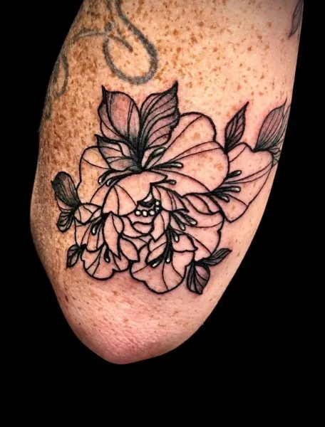 Peony and hibiscus — Fine-line botanical tattoo on upper arm